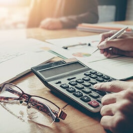 Calculator and financial documents on desk
